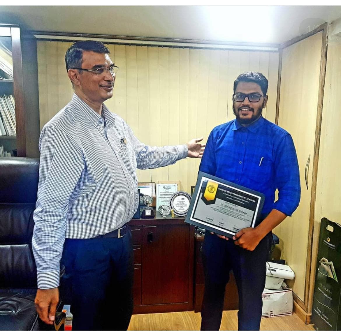 Dr. Md. Miftah Ur Rahman receiving a framed certificate presented by Dr. K Mahendranadh Reddy