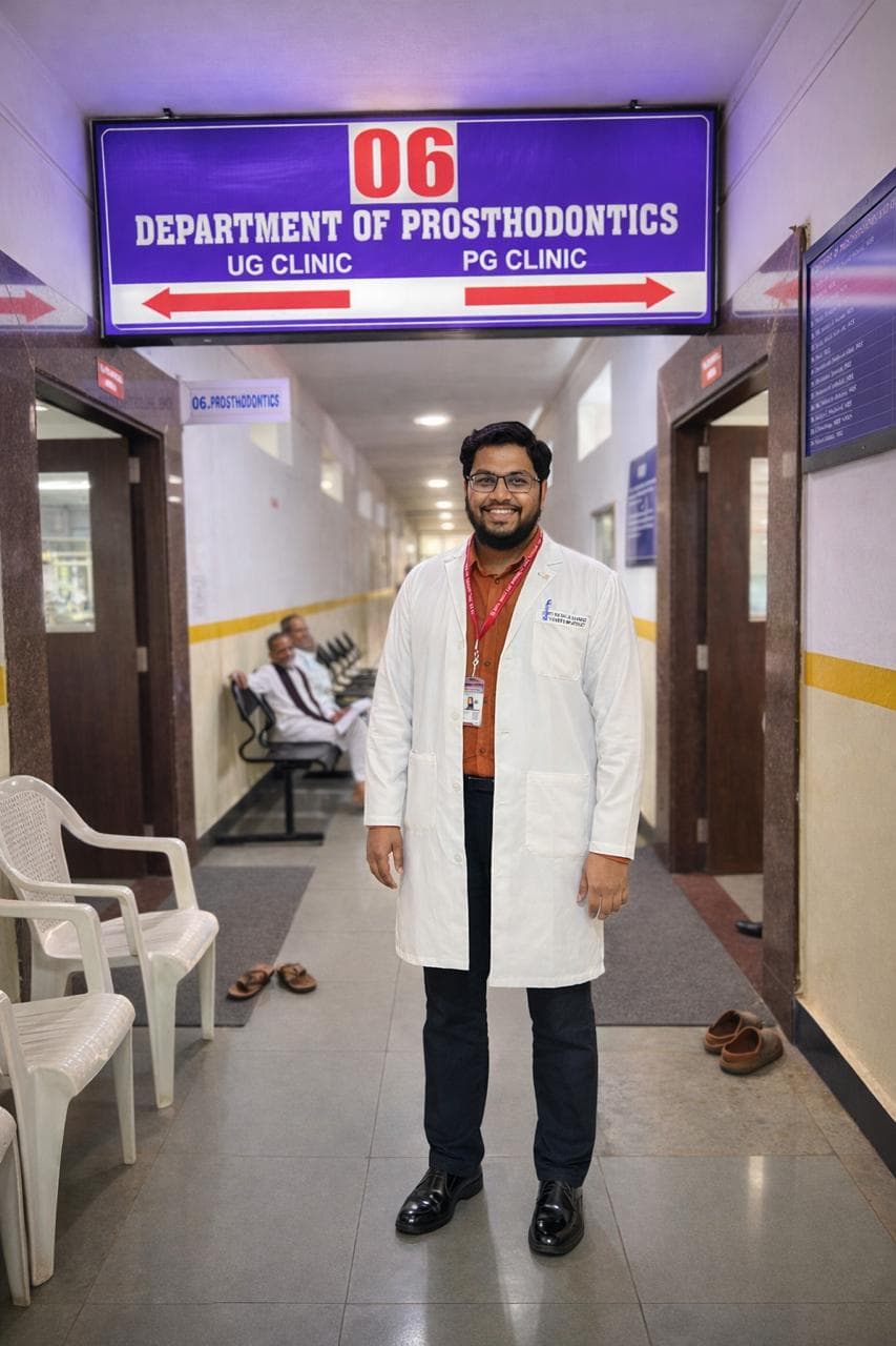 Dr. Md. Miftah Ur Rahman in a clinical coat at the entrance to the Department of Prosthodontics, SB Patil Dental College & Hospital